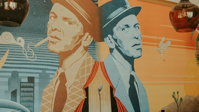 a mural of a man with a hat and tie
